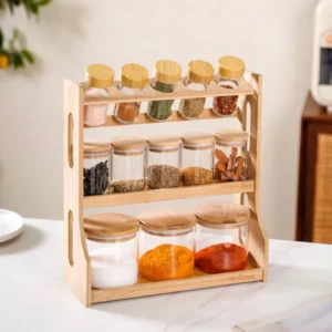 set of glass spice jars with bamboo lids and a bamboo storage rack.